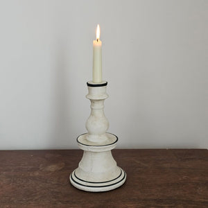 Add unique ambiance with the Chalky White Terracotta Taper Candlestick. Crafted from natural terracotta, this piece showcases an earthy texture beneath its soft chalky white finish, while delicate hand-painted black details add artisanal character. The beautifully imperfect design brings warmth and authenticity to any room, making it an ideal accent for farmhouse and country-inspired interiors seeking understated sophistication. 6" Diam x 10.5"H