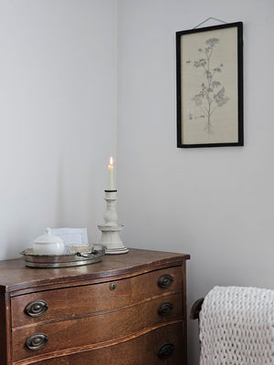 Add unique ambiance with the Chalky White Terracotta Taper Candlestick. Crafted from natural terracotta, this piece showcases an earthy texture beneath its soft chalky white finish, while delicate hand-painted black details add artisanal character. The beautifully imperfect design brings warmth and authenticity to any room, making it an ideal accent for farmhouse and country-inspired interiors seeking understated sophistication. 6" Diam x 10.5"H