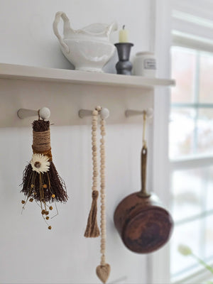 Know for good luck, the cinnamon broom has been traditionally used to sweep away negative energy and protect against unwanted influences when placed above doorways. Hand-crafted in the USA, our Cinnamon Broom Wall Accent comes decorated with dried flax stems, strawflower, and trimmed with golden ribbon and twine. This small broom is enhanced by the warm scents of cinnamon and clove essential oils.