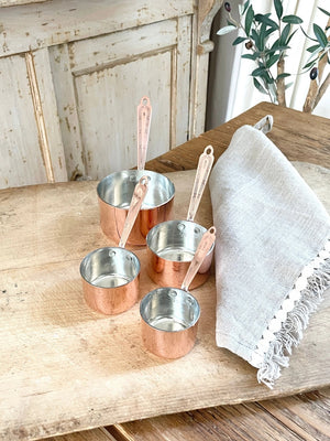 Rustic and timeless, these handcrafted vintage inspired Copper Measuring Cups will be your kitchen workhorse. Made from a very heavy gauge of solid copper, these measuring cups were inspired by an old Christofle cross and bow pattern from 1907, which is featured on each handle. Heirloom quality - made to be used, made to last, made to look good. Experience old European style in your own kitchen.