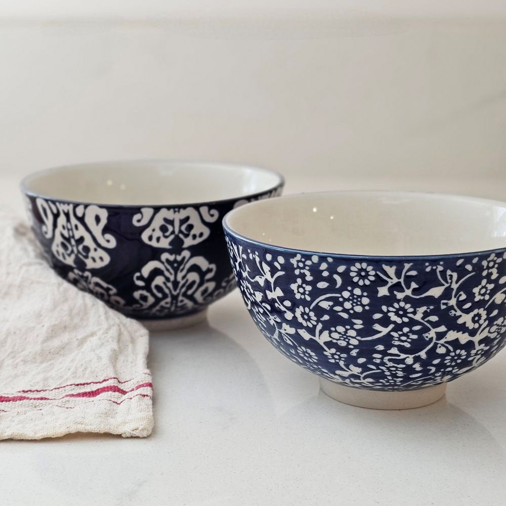 The Cordelia Blue and White Bowls evoke the feeling of vintage finds from the European countryside. These ceramic bowl feature classic blue and white designs. The sapphire blue glaze is etched with a floral design, revealing the cool white under-layer. The etching gives it an embossed, textured feel. These bowls are perfect for small servings of ice cream, rice and more. The set of includes two different floral patterns: small floral and block print style. Food safe. 