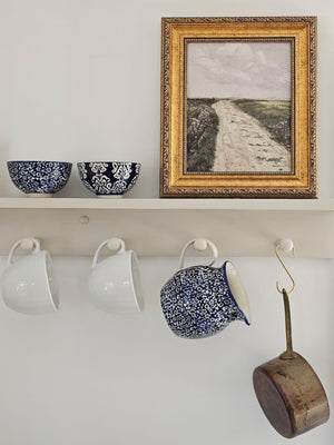 The Cordelia Blue and White Bowls evoke the feeling of vintage finds from the European countryside. These ceramic bowl feature classic blue and white designs. The sapphire blue glaze is etched with a floral design, revealing the cool white under-layer. The etching gives it an embossed, textured feel. These bowls are perfect for small servings of ice cream, rice and more. The set of includes two different floral patterns: small floral and block print style. Food safe. 