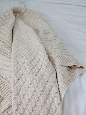 A nod to chunky knit sweaters, this cotton Cozy Cable Knit Throw offers heirloom quality and cozy comfort. The soft sand color and cotton knit suits any farmhouse style in any season. Perfect for getting comfy by the fire or curling up with a book or as a luxuriously soft cool option for summer. Hand wash recommended. Made of 100% Cotton. 50” x 60”