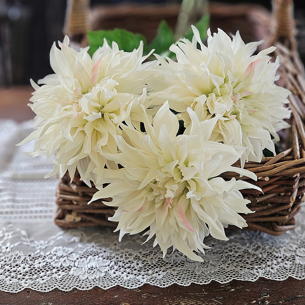 The Cream Dahlia Stem makes a stunning presentation. This faux floral is bursting with . realistic fabric petals with a soft hint of pink and rich green leaves. This Cream Dahlia stem is perfect for creating a farm table centerpiece that with wow-factor. Includes one stem to bring a touch of nature into your living space. 24"H