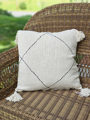 Whether it's on a bed or a cozy chair, you won't be able to resist this pillow's amazing texture. The Creamy Beige Accent Pillow with Black Stitching offers relaxed farmhouse elegance with its rustic look and fringed tassels.  The super soft fabric has an earthy, chunky weave, accented by a chunky black stitched design. Features a zippered closure for easy removal and care. Hand wash. 100% Cotton. Includes insert. 20" x 20"