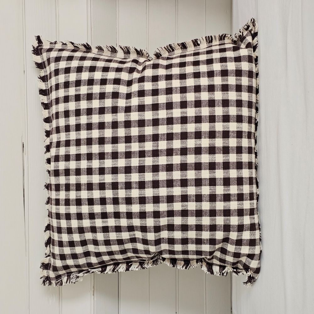 Enhance your living space with the Dark Brown Gingham Pillow, where timeless country charm meets refined design. Crafted from 100% cotton with a subtle off-white and dark brown gingham pattern, this pillow features elegant fringe edging and a discreet, easy-to-remove zipper. Its plush polyester insert offers both comfort and structure, making it a sophisticated accent that brings warmth and texture to any room. Spot clean only to preserve its quality. Measuring 18" x 18"