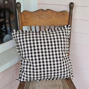Enhance your living space with the Dark Brown Gingham Pillow, where timeless country charm meets refined design. Crafted from 100% cotton with a subtle off-white and dark brown gingham pattern, this pillow features elegant fringe edging and a discreet, easy-to-remove zipper. Its plush polyester insert offers both comfort and structure, making it a sophisticated accent that brings warmth and texture to any room. Spot clean only to preserve its quality. Measuring 18" x 18"