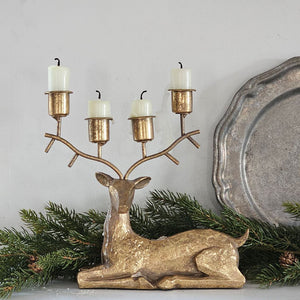 Add a mystical woodland touch with the Golden Deer Antler Candelabra. Its sparkling gold antiqued finish lends a feeling of enchantment, while its stonepowder resin construction ensures durability. This candelabra holds four tapers, perfect for creating a cozy and magical ambiance.