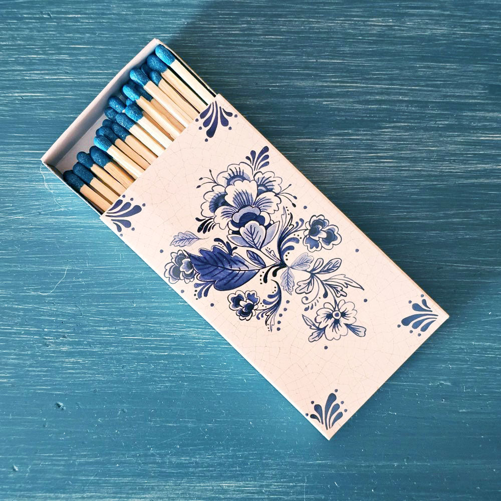 These stylish wood matches, with a Delft Blue Tile Design, are the perfect complement to any space. Modern, chic, with a vintage graphic design, they are perfect for any room. The match striker is side of the box for easy lighting. Safety matches, 50 sticks per cardboard box.