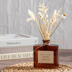 Dried flowers have been added to this scented reed difusser for a charming twist. Dried floral stems mix with classic diffuser reeds to create a fragrance diffuser that is both functional and stylish!&nbsp; This difusser will fill your home with an inviting scent, while the floral stems add natural beauty. It’s the perfect diffuser for a bedside, home office or reading room. Comes in a vintage style amber glass bottle as shown. 7 fluid ounces.