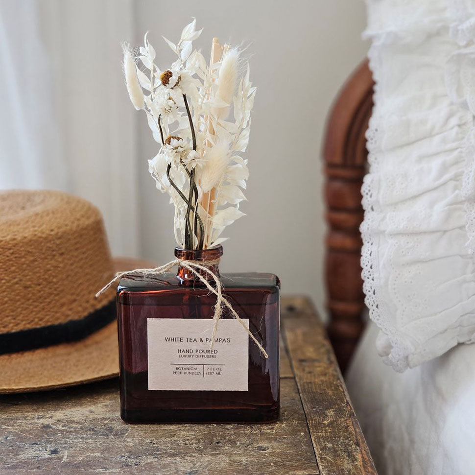 Dried flowers have been added to this scented reed difusser for a charming twist. Dried floral stems mix with classic diffuser reeds to create a fragrance diffuser that is both functional and stylish!&nbsp; This difusser will fill your home with an inviting scent, while the floral stems add natural beauty. It’s the perfect diffuser for a bedside, home office or reading room. Comes in a vintage style amber glass bottle as shown. 7 fluid ounces.