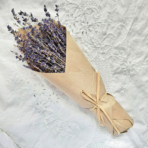 Our French Lavender Bouquet is a nod to the timeless elegance of the French countryside. This dried French Lavender is cultivated by generations of passionate French farmers. Each 80-gram bunch stands as a testament to tradition and quality. Wrapped in Kraft paper that resonates with nostalgia, this lavender is a journey back in time. Hand-wrapped and graced with a natural raffia bow, it's more than just lavender; it's a piece of history. Each bundle is approximately 14" long. Made in France.