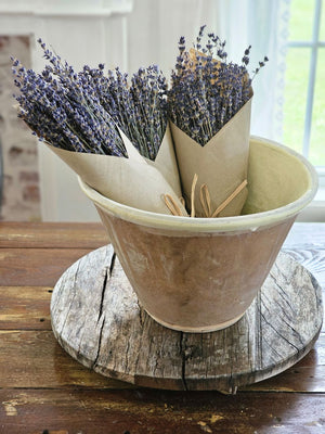 Our French Lavender Bouquet is a nod to the timeless elegance of the French countryside. This dried French Lavender is cultivated by generations of passionate French farmers. Each 80-gram bunch stands as a testament to tradition and quality. Wrapped in kraft paper that resonates with nostalgia, this lavender is a journey back in time. Hand-wrapped and graced with a natural raffia bow, it's more than just lavender; it's a piece of history. Each bundle is approximately 14" long. Made in France.