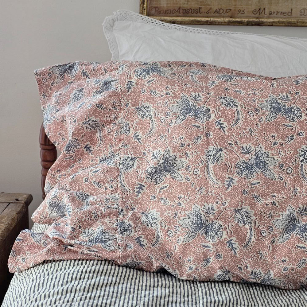 Add beautiful texture and vintage style to your bedroom with the Dusty Rose Blue Floral Pillow Case Set. Features a soft dusty rose case with a navy blue and creme floral pattern that coordinates well with other patterns. An generous 8-inch ruffle lends a country cottage elegance. The 100% cotton weave features a crisp, vintage feel. Create a layered look by mixing and matching bedding styles and patterns. Set of two standard. Each measures 21x26