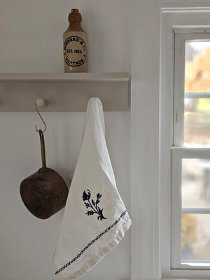 This premium tea towel is not only aesthetically pleasing with its embroidered floral design, but also highly practical. The Embroidered Dish Towel with Delft Blue Sprig features beautiful blue embroidery in a design inspired by delft pottery. It's perfect for everyday use, easily handling spills and kitchen messes with grace. Maintaining its freshness is also as easy as a quick machine wash. 18" x 28"