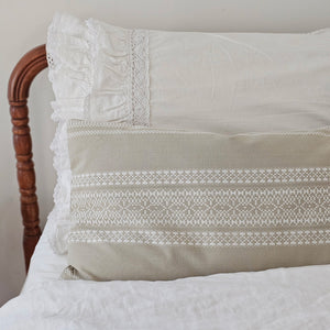 Elevate your decor with our Embroidered Dobby Weave Pillow. Its intricate geometric pattern and dobby weave add a touch of boho flair. Made with 100% yarn-dyed cotton and loft polyester filling, it combines comfort and style for a well-traveled look in any room. Features a tan linen color with crisp white embroidery. 24"L x 12"H