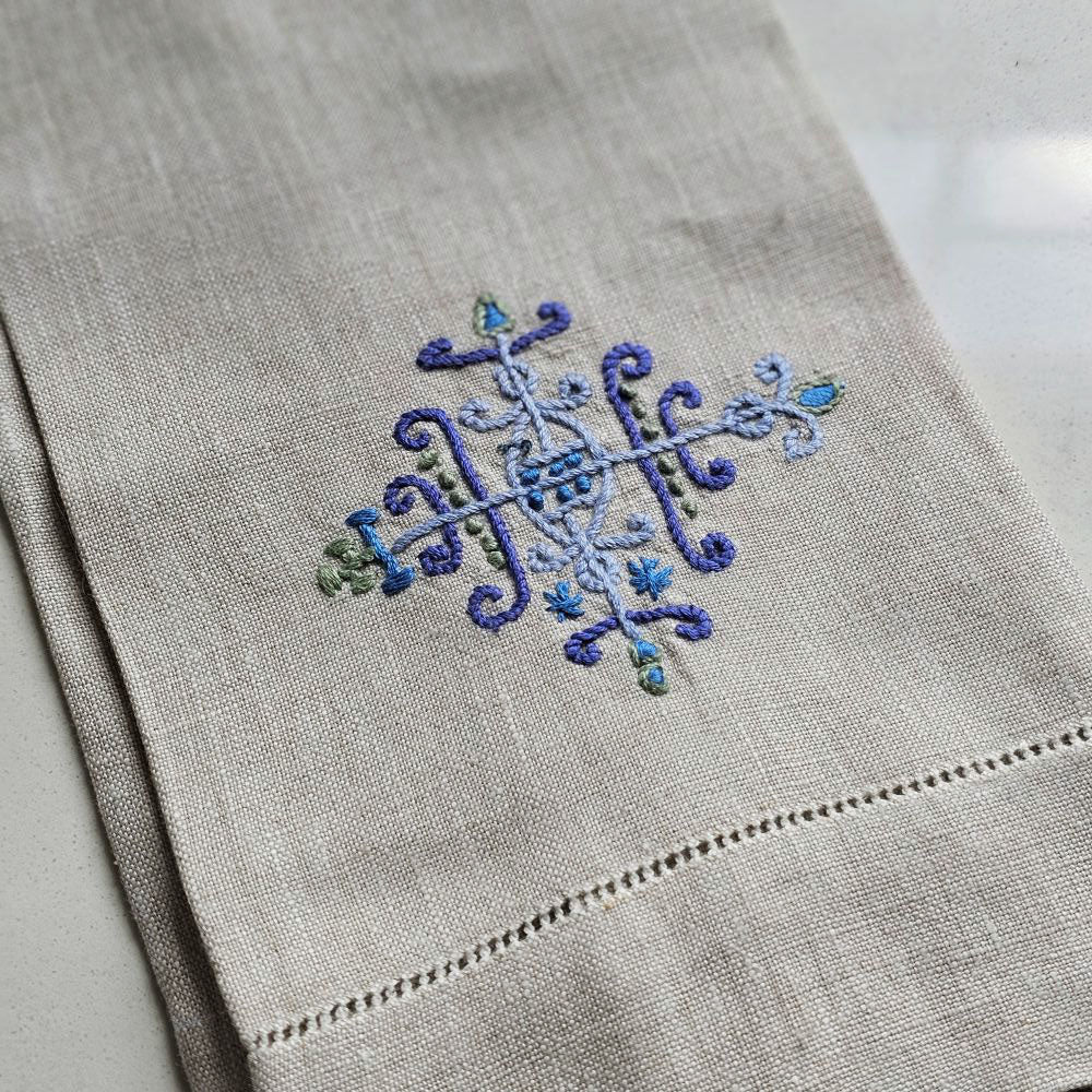 This premium linen tea towel is not only aesthetically pleasing with its hand-embroidered design, but also highly practical. The Embroidered Flax Linen Tea Towel features a beautiful hand-embroidered design in light blue, lavender and green. The intricate detail makes our tea towels the perfect housewarming gift or addition to any kitchen or bathroom. 100% Linen. Machine wash. 13" x 25.5"H