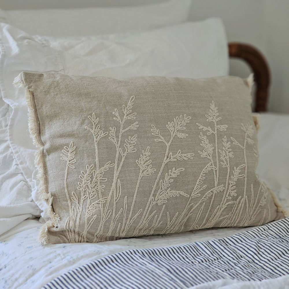 Add relaxed, down-to-earth style with our Embroidered Meadow Grasses Pillow. Made with 100% cotton, this accent pillow features a flax linen look, with a warm oatmeal color and rustic texture. The embroidered meadow grass design and fringe sides lend added texture and style. Pillow features a zipper to easily remove and clean cover. Includes polyester insert. 20"L x 14"H