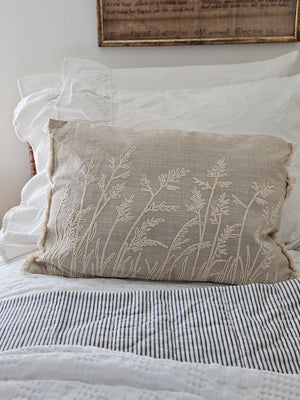 Add relaxed, down-to-earth style with our Embroidered Meadow Grasses Pillow. Made with 100% cotton, this accent pillow features a flax linen look, with a warm oatmeal color and rustic texture. The embroidered meadow grass design and fringe sides lend added texture and style. Pillow features a zipper to easily remove and clean cover. Includes polyester insert. 20"L x 14"H