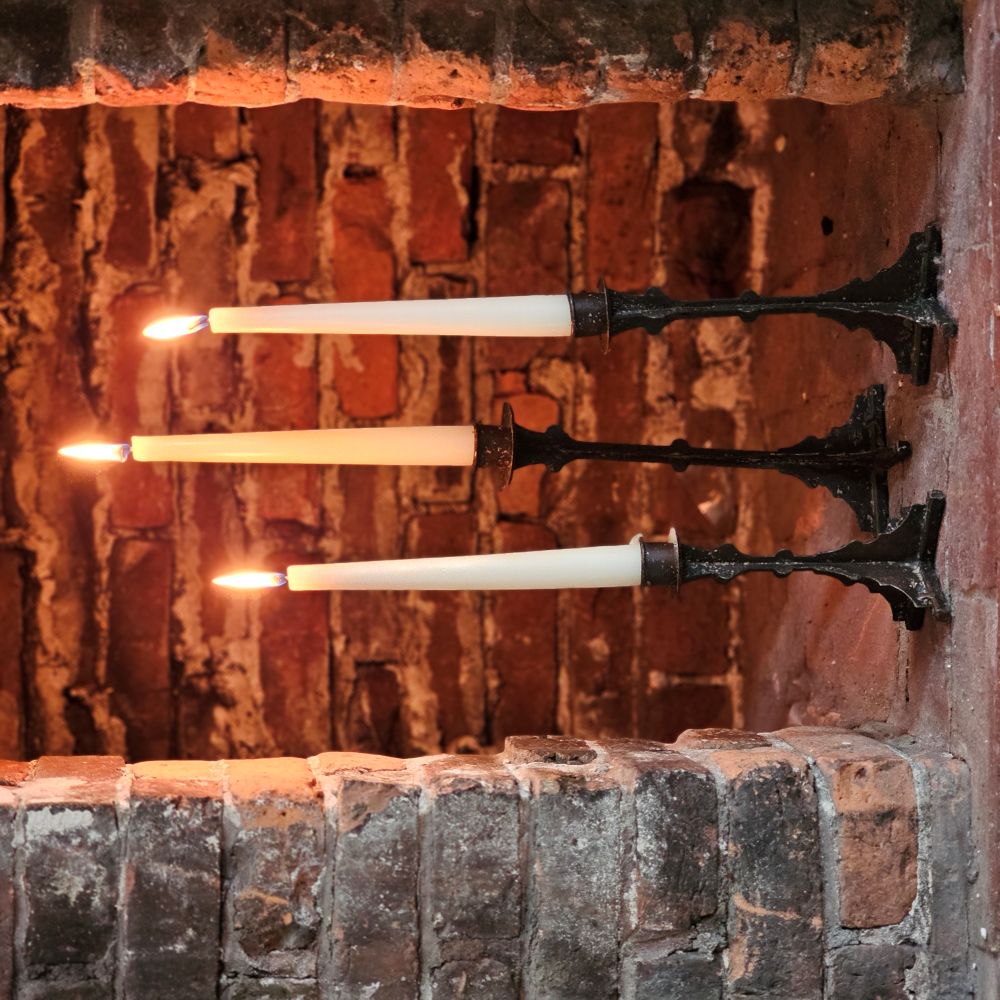 The Emil Bronze Style Taper Candle Holder Set lends old-world ambiance to any occasion. This set of three metal taper candle holders features a sculptured look and highly distressed brown finish. The aged bronze style finish has a time-worn patina, inspired by antique shop finds. Add to a bookshelf, bedside table, or create a stunning centerpiece on a long farm table by weaving a few among a garland of greenery. Holds regular tapers. Candles not included.