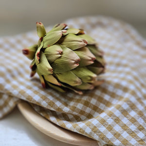 Add a rustic, earthy touch with these handcrafted fabric artichoke heads. Each of the three has a bit of aging on the edges for a realistic look, making them perfect for decorating bowls or pots. An ideal way to add charm to your home decor! Set of three. 3.5" x 4"H