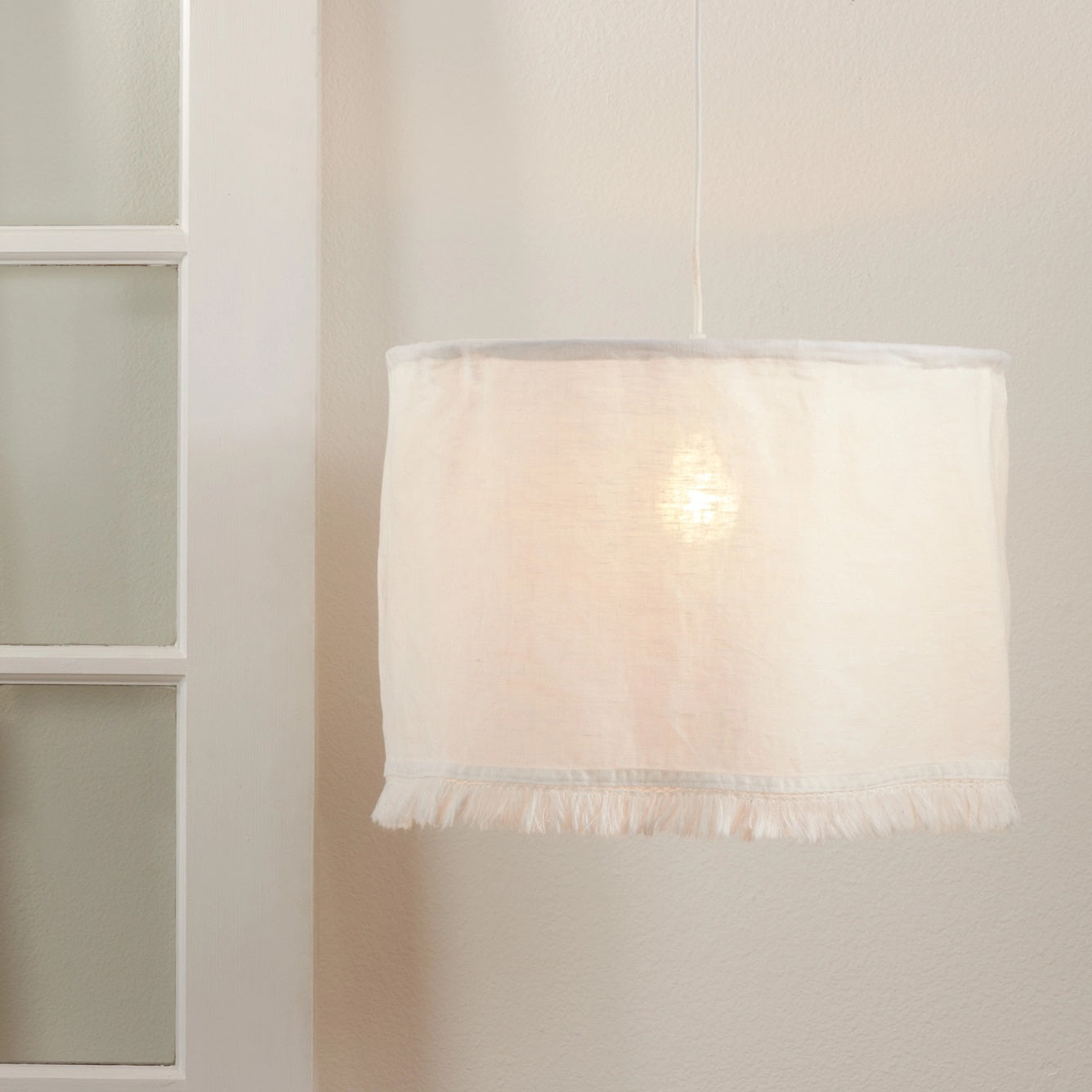 Add a relaxed and rustic feel to your home with this Linen Fabric Pendant Lampshade. The soft linen material and fringed bottom trim create a sweet cottage farmhouse look, perfect for any room. This lampshade is designed to be used with an existing pendant light fixture (not included). Shade only. 18" Diam x 12"H
