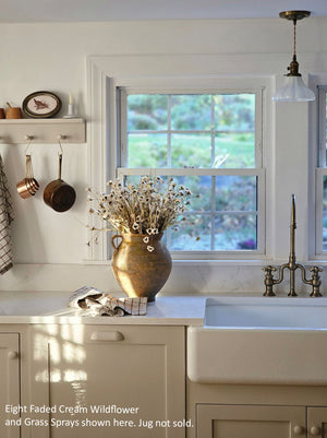 Farmhouse cottage style is made easy with our Faded Cream Wildflower and Grass Spray. This faux flower spray features a lush array of sweet daisy-like blossoms and wispy grasses. The stem is long, slender, and flexible and is easily shaped for a desired look. It can be displayed alone for a simple country look or arranged into a bouquet.