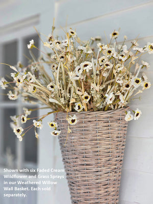 Farmhouse cottage style is made easy with our Faded Cream Wildflower and Grass Spray. This faux flower spray features a lush array of sweet daisy-like blossoms and wispy grasses. The stem is long, slender, and flexible and is easily shaped for a desired look. It can be displayed alone for a simple country look or arranged into a bouquet. It easily fits into baskets, buckets, and milk cans and more.