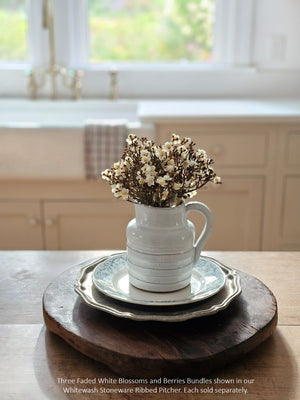 The Faded White and Berries Bundle features small, creamy white blooms with hints of pink and beige that are accented with berries to create the sweetest collection that brings a massive load of charms to displays. Each bundle contains seven stems. 7"H
