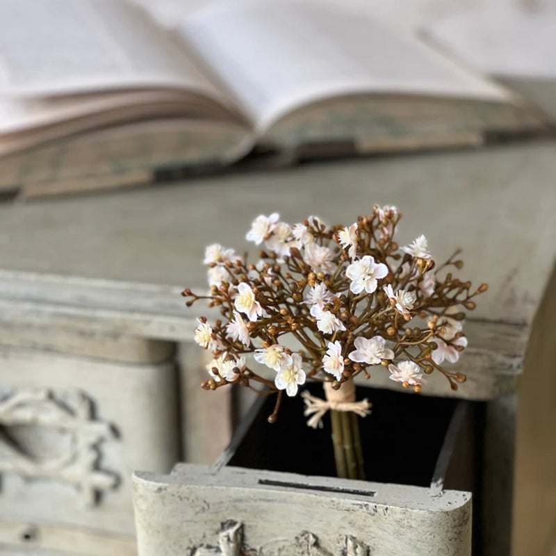 The Faded White and Berries Bundle features small, creamy white blooms with hints of pink and beige that are accented with berries to create the sweetest collection that brings a massive load of charms to displays. Each bundle contains seven stems. 7"H