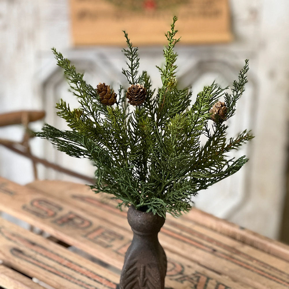 Our Forest Green Pine Pick, Featuring lovely shades of green and a peppering of pine cones, makes a gorgeously versatile addition to any display. makes a great filler for baskets and holiday arrangements. The Forest Pine Pick brings fresh, earthy greenery to your farmhouse decor. Perfect for adding cabin style or a rustic twist, this realistic greenery with pinecone accents provides a charming decorative accent all year long.