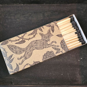 These stylish wood matches, with a fox and hare design, are the perfect complement to any space. Modern, chic, with a vintage graphic design, they are perfect for any room. The match striker is side of the box for easy lighting. Safety matches, 50 sticks per cardboard box. Includes set of two boxes.