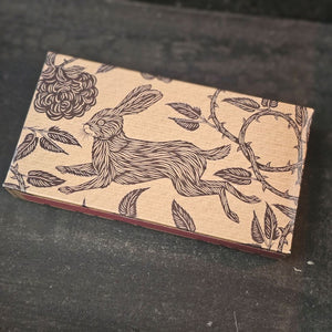 These stylish wood matches, with a fox and hare design, are the perfect complement to any space. Modern, chic, with a vintage graphic design, they are perfect for any room. The match striker is side of the box for easy lighting. Safety matches, 50 sticks per cardboard box. Includes set of two boxes.