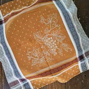 The French Country Woven Jacquard Napkin brings authentic Provence charm to your table. Handwoven in France, this 20" x 20" napkin features a timeless grape motif in warm caramel, burgundy, navy, and beige tones. Each piece combines classic design with rustic elegance, perfect for everyday dining or special gatherings. A curated accent for farmhouse and traditional decor. Each sold separately. 20 x 20"