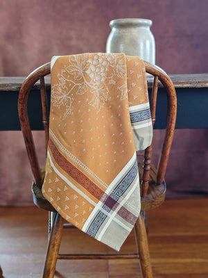 The French Country Woven Jacquard Napkin brings authentic Provence charm to your table. Handwoven in France, this 20" x 20" napkin features a timeless grape motif in warm caramel, burgundy, navy, and beige tones. Each piece combines classic design with rustic elegance, perfect for everyday dining or special gatherings. A curated accent for farmhouse and traditional decor. Each sold separately. 20 x 20"
