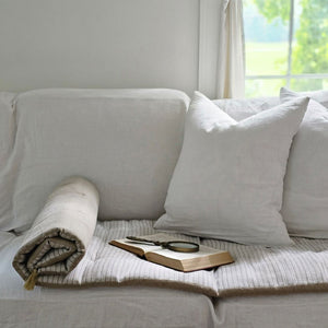 Enhance your space with our French Mattress Sofa Pad, crafted to add comfort and texture to any area. With its classic French linen weave and neutral taupe and white stripes, this vintage style ticking stripe pad is adds a comfortable layer to sofas, window benches, and outdoor lounges. Plus, its complementary tassels add a stylish touch. Spot clean for easy maintenance.