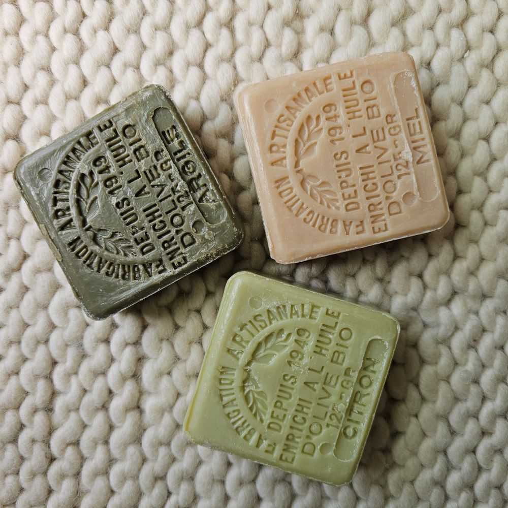 These authentic 100% natural and organic french soaps are made with pure olive oil. The delicate scents fill the air with fresh, clean aromas as you soothe and soften skin with nurturing olive oil. Each soap is stamped for added beauty. Fill a jar and create a beautiful accent for your bath. Set of three. The set includes one lemon or lavender, one honey and one clay soap. Each 4.41oz