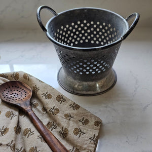 Made of galvanized metal, our Rustic Tin Colander is a decorative colander with a weathered, distressed finish. It has a widened base, a repeating hole pattern, and a pair of carrying handles. Create the perfect centerpiece for your farm table or add to any kitchen shelf for instant charm. This Rustic Tin Colander makes the ideal display for dried flowers, potpourri, decorative eggs
