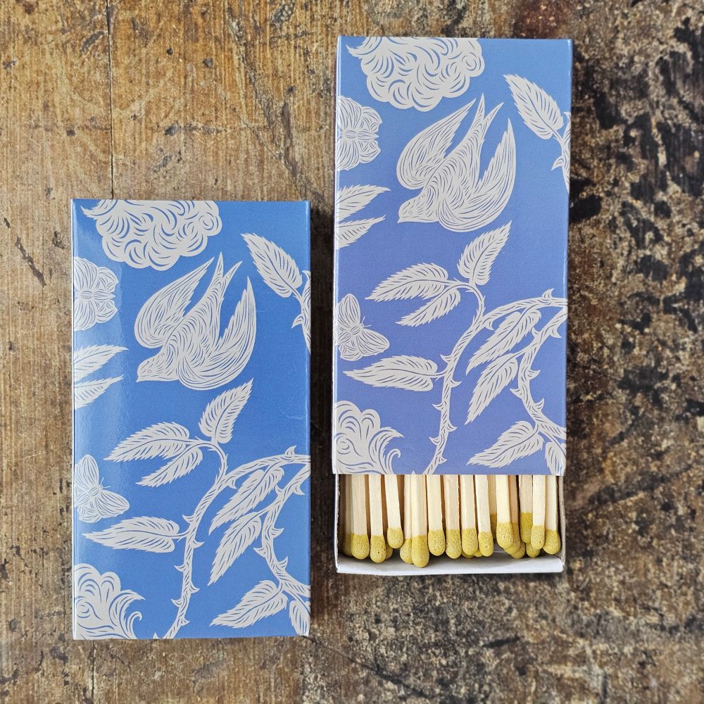 These stylish wood matches, with a garden bird design, are the perfect complement to any space. Modern, chic, with a vintage graphic design, they are perfect for any room. The match striker is side of the box for easy lighting. Safety matches, 50 sticks per cardboard box. Includes set of two boxes.