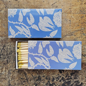 These stylish wood matches, with a garden bird design, are the perfect complement to any space. Modern, chic, with a vintage graphic design, they are perfect for any room. The match striker is side of the box for easy lighting. Safety matches, 50 sticks per cardboard box. Includes set of two boxes.