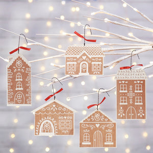 This Gingerbread Dutch Village Ornament Set makes a cheerful holiday accent. The set of five decorative ornaments comes in the shape of various gingerbread house designs. These seasonal ornaments feature natural wood with white color designs to give the appearance of icing decorated gingerbread. Designs are made with textured resin for a snowy detail. Each gingerbread house ornament hangs for display via attached twisted wire hangers with red ribbon accents.