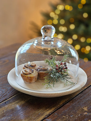 Elegant entertaining is made easy with our Glass Cloche with Wood Tray. Create a timeless presentation with this bell jar style cloche and natural wood plate. In addition to serving guests in style, this cloche and tray combo makes a great way to display small objects and keepsakes, such as bird nests and more. The wood plate is natural--with no finish and measures 8.5" dia. The Glass cloche measures 6.75" diam x 5.50"H