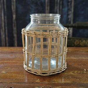This Glass Jar with Willow Basket Sleeve brings French Country cottage charm to your home or garden decor. The thick, clear glass jar insert allows you to enjoy it as an elegant candle hurricane or use it as vase packed with your favorite flowers. You can use the pieces separately. The Glass jar is beautiful for storage or display while the willow basket makes an attractive sleeve for garden pots. 7” diam x 9”H