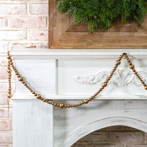 Deck the halls with our Gold Bead Garland, a refined accent that brings warmth and sophistication to mantels, garlands, and seasonal greenery. Crafted from lustrous wood beads with a radiant golden finish, this garland creates an understated yet striking glow that complements both traditional and contemporary holiday displays.