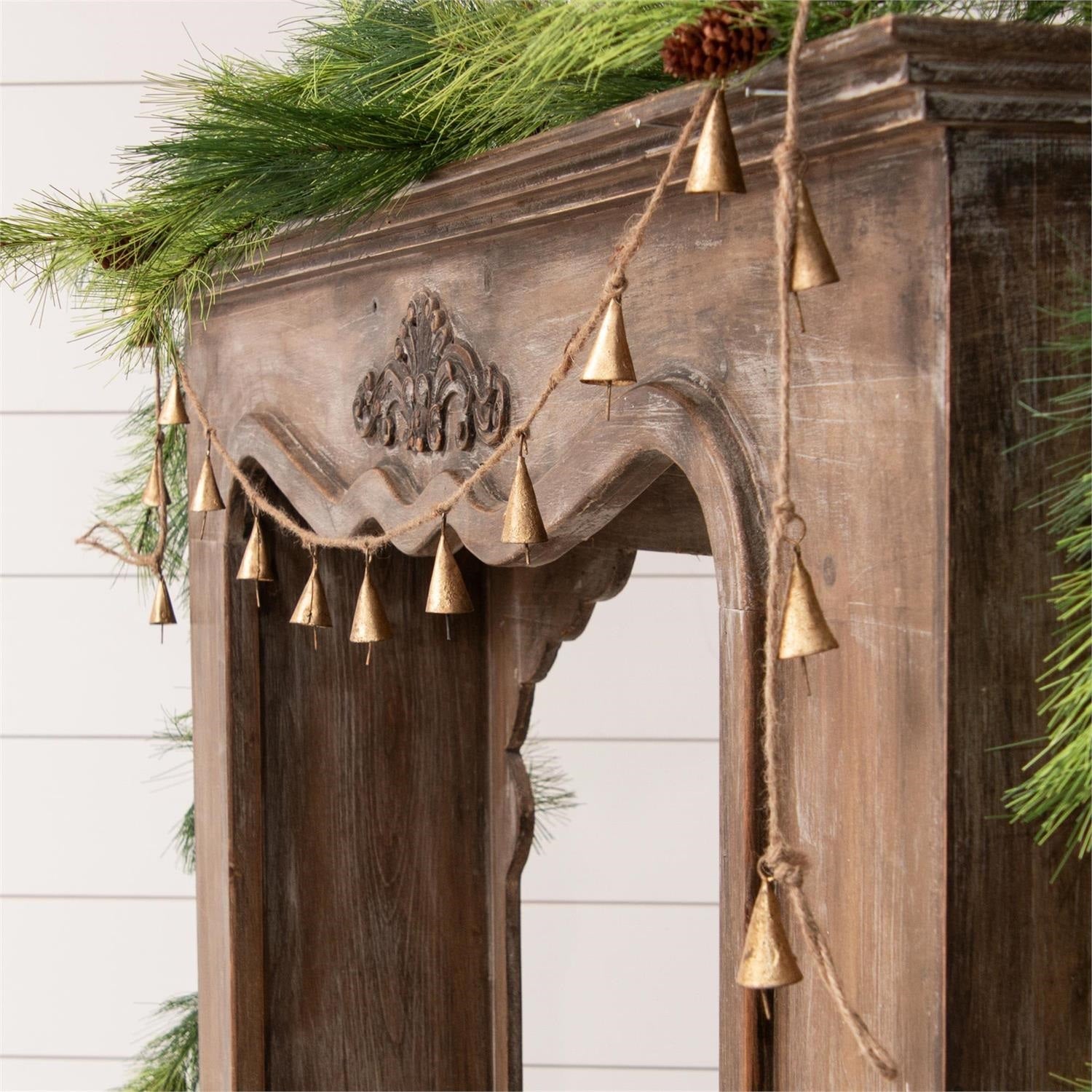 This Gold Finish Cone Bell Garland adds an old-world charm to your holiday decor. Crafted with an aged gold finish, the cone shaped bells offer a timeless look--perfect for bringing a calming touch into your festivities. 75.5"L x 2"H