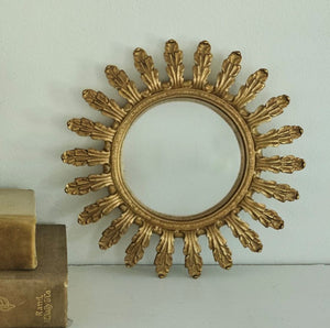 This vintage style Gold Leaf Convex Wall Mirror lends instant ambiance to any room. This round convex mirror has an aged gold finish with a leaf motif for a luxurious look. The ornate design will add a touch of sophistication and antique style charm to your home. The convex mirror has a curved reflective surface that bulges outward toward the light source. Includes a sawtooth hanger on back for hanging. Polyresin. 7.6" Diam