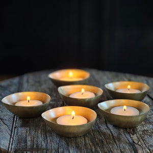 A simple and elegant way to add shimmering candlelight to any room. The antiqued brass of these Gold Tea Light Candle Bowls perfectly catches the glow of each flame. Tealight Candle not included. Set of six. Each is 2.50"W x 1"H