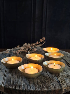 A simple and elegant way to add shimmering candlelight to any room. The antiqued brass of these Gold Tea Light Candle Bowls perfectly catches the glow of each flame. Tealight Candle not included. Set of six. Each is 2.50"W x 1"H