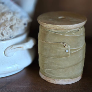 The Gold Velvet Ribbon on Wood Spool Dispenser features a lush velvet with a greenish gold luster. Add a little function to your craft room with this wood spool or just keep this beauty on display. Features a faux pearl pin. 1" ribbon. 10 yards each spool. Wood Spool measures: 3” Diam x 4”H