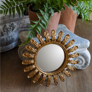 This vintage style Gold Leaf Convex Wall Mirror lends instant ambiance to any room. This round convex mirror has an aged gold finish with a leaf motif for a luxurious look. The ornate design will add a touch of sophistication and antique style charm to your home. The convex mirror has a curved reflective surface that bulges outward toward the light source. Includes a sawtooth hanger on back for hanging. Polyresin. 7.6" Diam